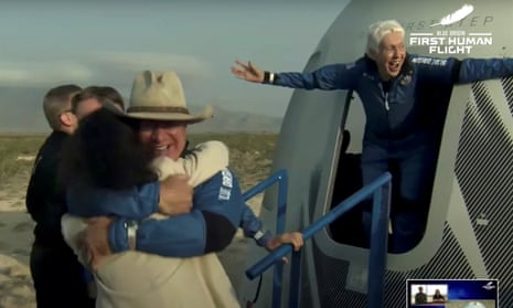 Wally Funk, right, wearing a blue jumpsuit, emerges from a capsule with a look of joy and her arms flung wide after the flight aboard Blue Origin’s New Shepard rocket.
