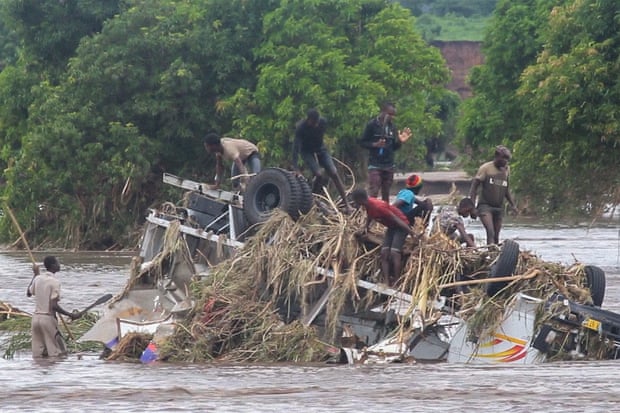 An overturned vehicle swept by flooding waters in Chikwawa, Malawi