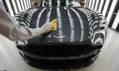 An employee polishes the bodywork of an Aston Martin DB11 at the carmaker’s plant in Gaydon, Warwickshire
