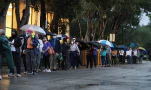 Voters wait in line to cast their early ballots at the Coral Gables Branch Library precinct in Florida.
