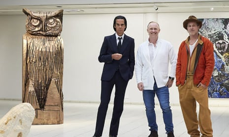 British artist Thomas Houseago (C) poses with US actor Brad Pitt (R) and Australian musician Nick Cave prior to the opening of their joint exhibition in Tampere, Finland.