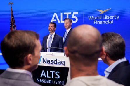 Two men side by side in front of a Nasdaq podium