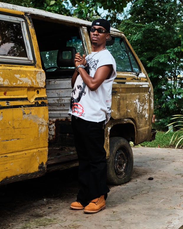 Toby Shang stood next to a broken down old school bus