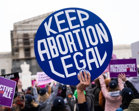 closeup of hand holding a sign that reads 'keep abortion legal'