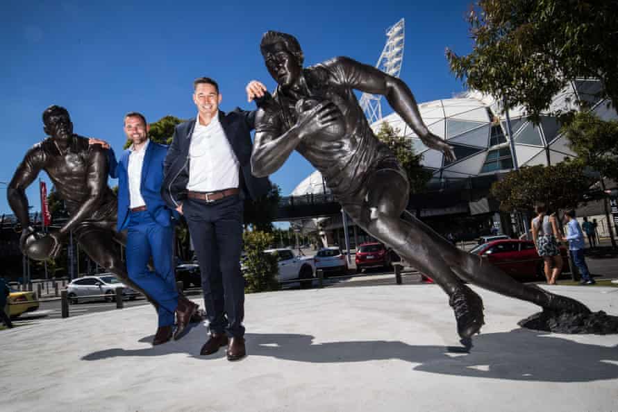 Cameron Smith poses with Billy Slater alongside their statues outs AAMI Park.