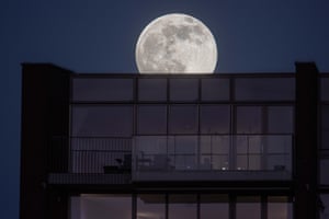 The full moon rises over a residential area near Eindhoven in the Netherlands