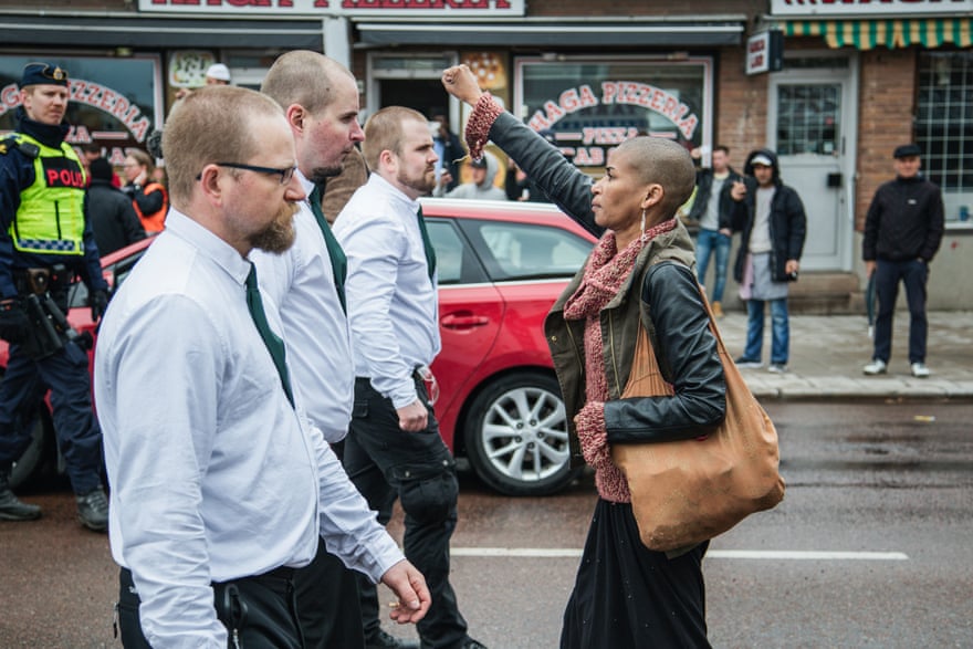 A lone woman stands up to uniformed demonstrators in a Nazi demonstration in Borlänge, Sweden on 1 May, 2015.