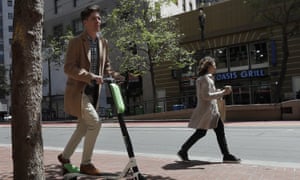 man rides scooter in SF
