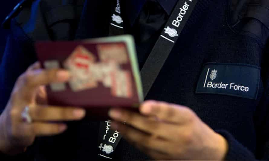 A borderline unit serviceman checks a passport.