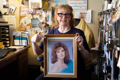 On her 72nd birthday, 20 June 2023, Nancy McGuire poses for a birthday portrait while holding a photo taken of her when she was 42.