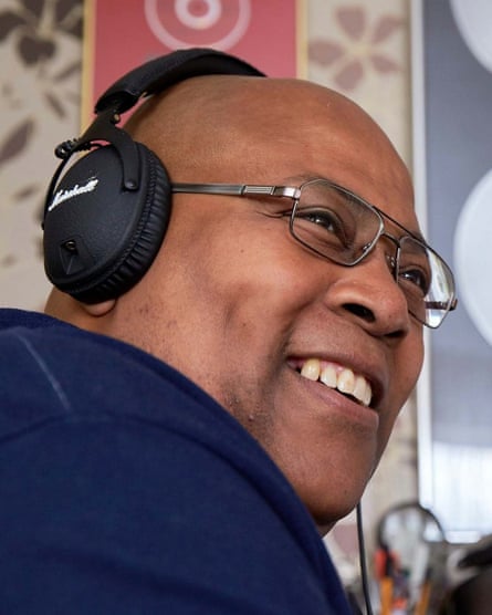 Alfred Samuels smiles while wearing a pair of headphones