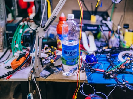 A shot of a table top at the workshop, covered in wires and tools and equipment