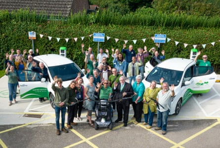 Crowd of people stood around two eletric cars with ‘Green Fox’ branding.