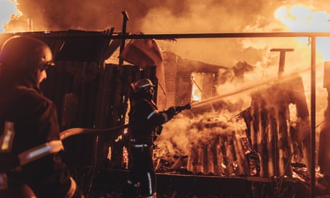 Emergency service workers extinguish a fire in a house after a Russian shelling in Kostiantynivka, Ukraine on March 18, 2023. (Photo by Diego Herrera Carcedo/Anadolu Agency via Getty Images)