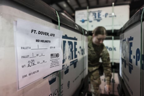 US Air Force Airwoman Megan Konsmo, from Tacoma, Washington, checks pallets of helmets bound for Ukraine in the Super Port of the 436th Aerial Port Squadron on Friday.