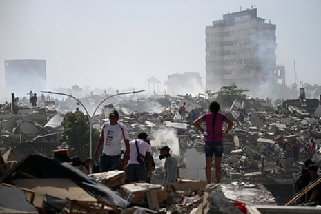 People search for possible victims near collapsed buildings.