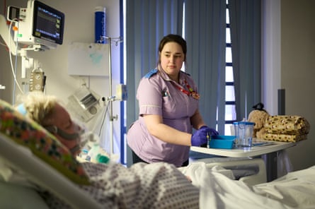 A patient having a non invasive ventilation mask fitted on the respiratory ward.