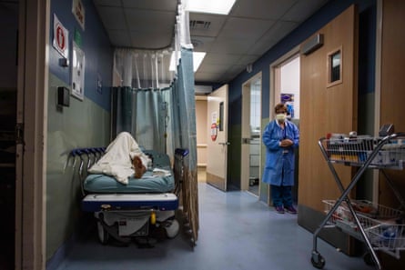 A patient rests in a corridor waiting for a room at Providence Cedars-Sinai Tarzana Medical Center in Tarzana, California on January 3, 2021.