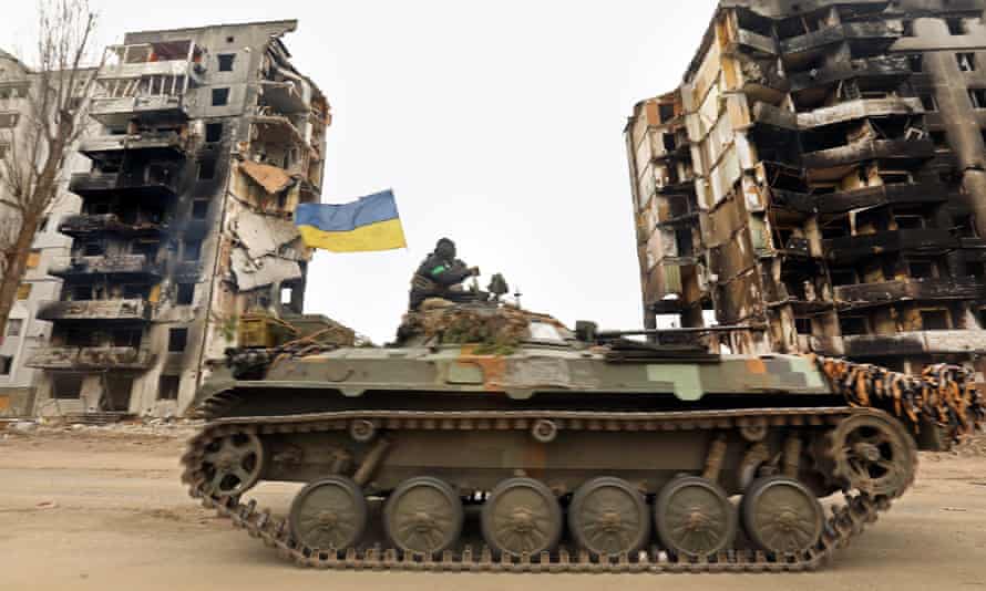 Ukrainian forces move through the town of Borodyanka.