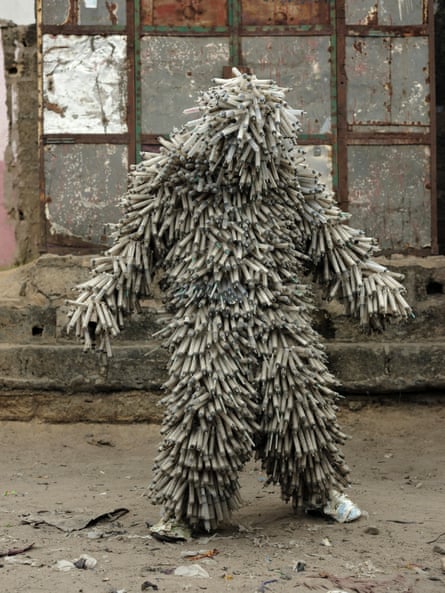 Flory Sinanduku with his costume made of syringes.
