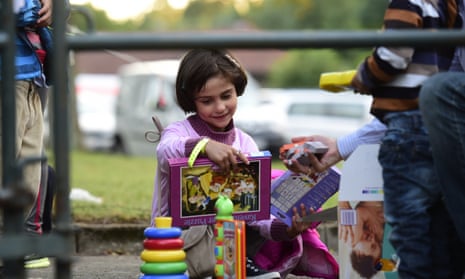A young refugee girl plays with game she received upon arrrival at a former Fire station in Celle, northern Germany