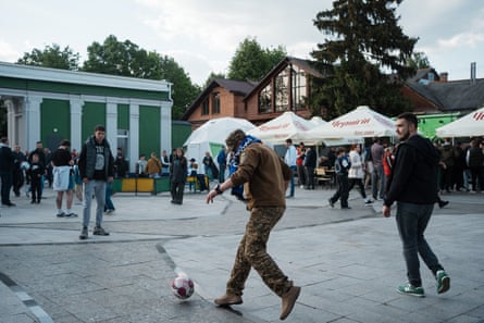 Fans, including a serviceman, have a kickabout before the Ukrainian Cup final.