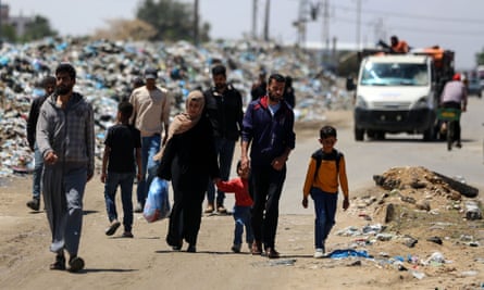 Displaced Palestinians walk as they head for Khan Younis from Rafah in the southern Gaza Strip on 6 May.