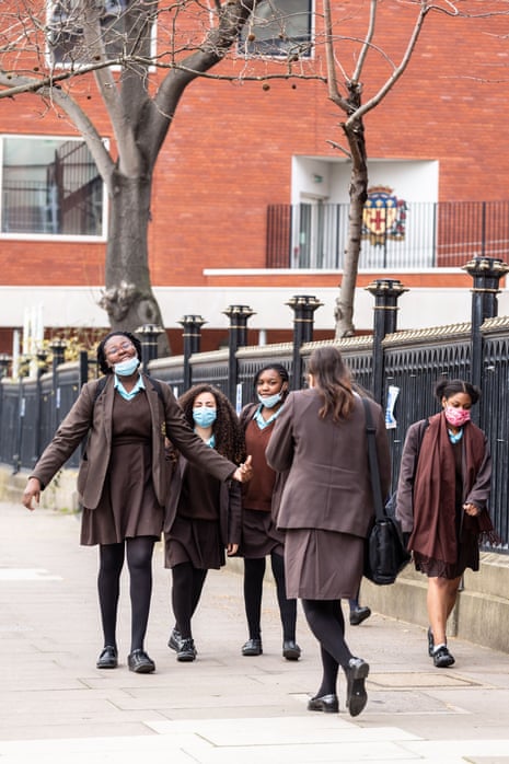 Students of Notre Dame secondary school walk out from the building after the first day at school in southern London as schools in England reopen on 8 March, 2021.