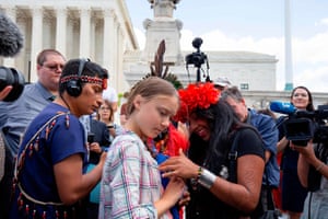A seemingly pensive Greta Thunberg listens to Militza Flaco (R) from the Global Alliance of Territorial Communities Guardians of the Forest after a gathering outside the US Supreme Court after the congressional hearing this morning, to support the youth climate lawsuit against the US government.