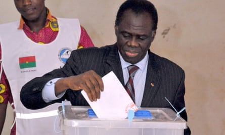Burkina Faso’s transitional president Michel Kafando casts his vote for the presidential election at a polling station in Ouagadougou.