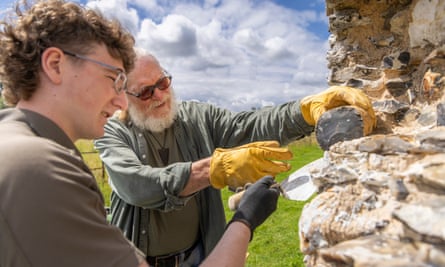 Flintknapper John Lord, 81, (right) and Myles Mathias, 21, at Castle Acre priory in Norfolk