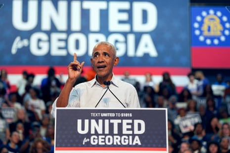 Man in button-down shirt speaks with a finger pointed at lectern marked 'United for Georgia' as a crowd watches