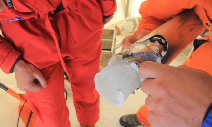 Scientist holding a freshly harvested ice sample from the Mont Blanc site.