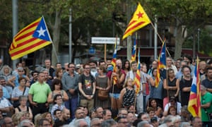 People holding Catalan pro-independence estelada flags