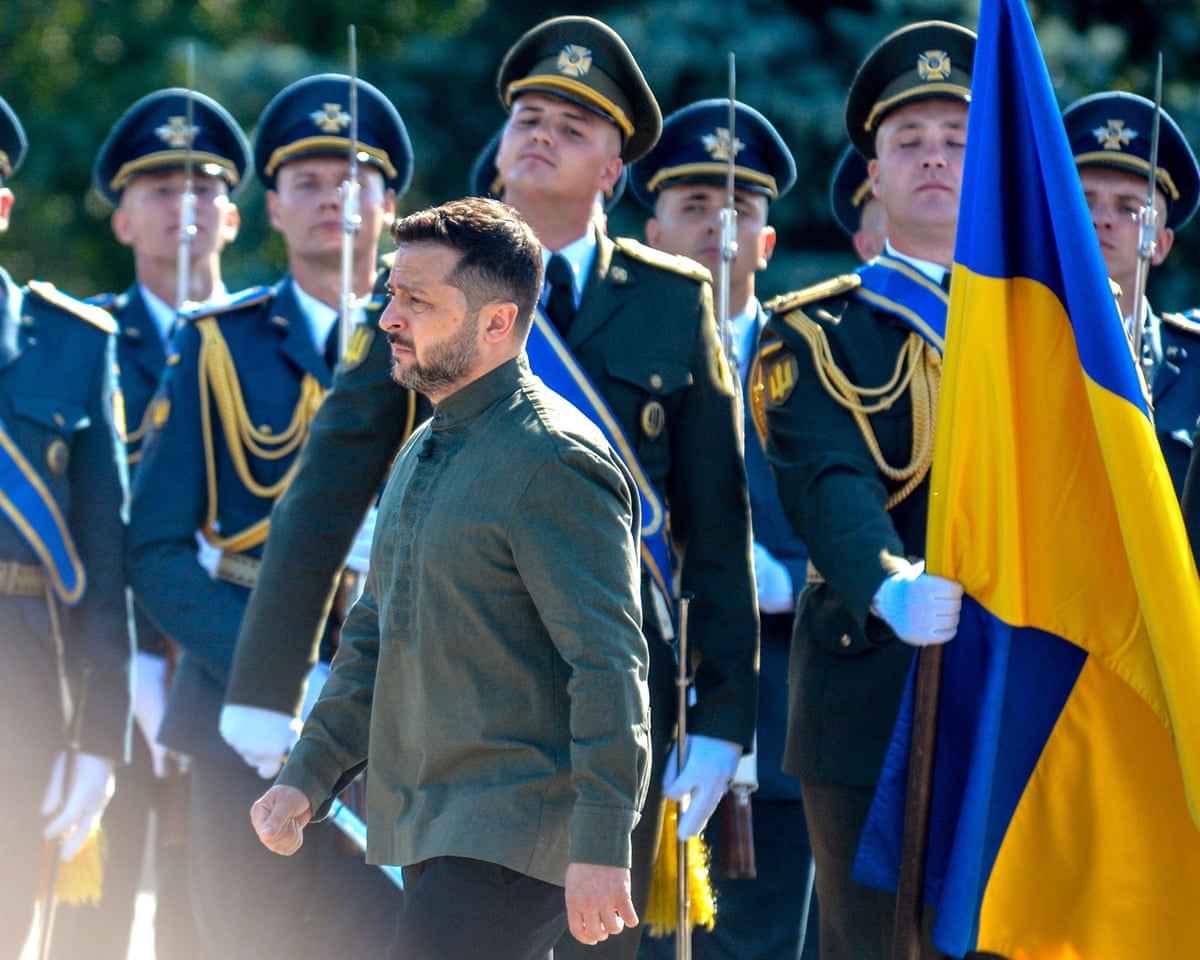 President of Ukraine Volodymyr Zelenskyy walks past honour guards during the raising of the State Flag at the National Museum of the History of Ukraine in Kyiv.
