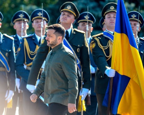 President of Ukraine Volodymyr Zelenskyy walks past honour guards during the raising of the State Flag at the National Museum of the History of Ukraine in Kyiv.