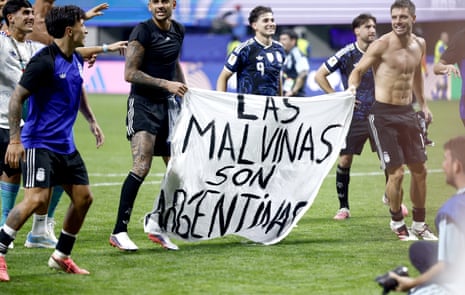 Players of Argentina hold the banner yesterday.