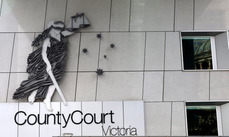 Logo of the Victoria county court outside the courthouse attached to a white building