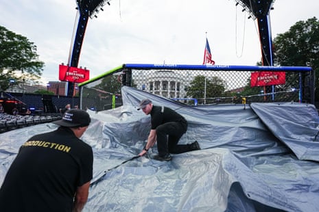 UFC rain crew prepare tarps Sunday on the South Lawn at the White House.