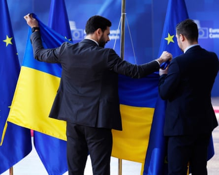 Members of protocol put up the Ukrainian flag prior to the arrival of Volodymyr Zelenskyy during an EU Summit
