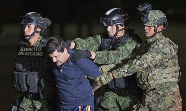 In an 8 January 2016 file photo, Mexican soldiers escort drug lord Joaquín ‘El Chapo’ Guzmán to a helicopter to be transported to a maximum security prison.