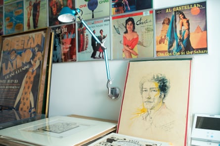 A portrait of graphic designer Izzy Sanabria at the archive, with some of the many salsa and mambo album covers he designed.