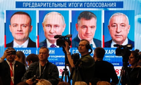 Journalists in front of a screen showing election results