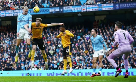 Erling Haaland rises to win a header for Manchester City against Wolves