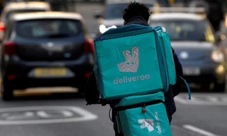 Deliveroo delivery rider cycles in London
