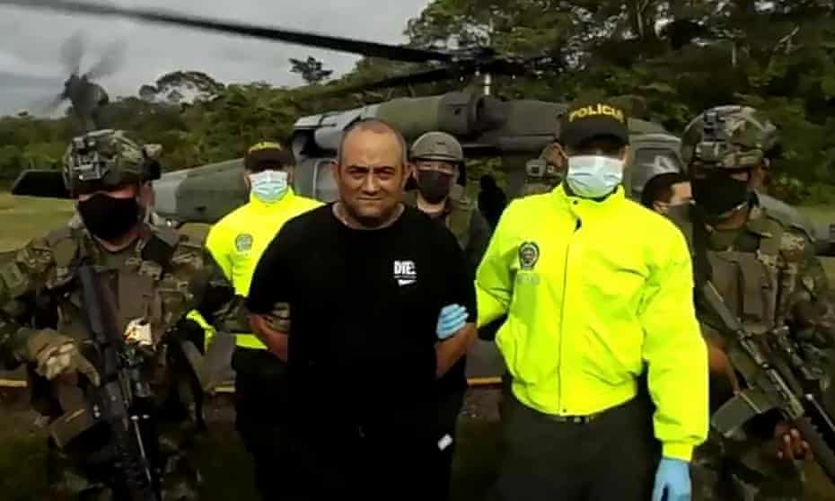 Police escort Colombia's most-wanted drug lord, Dairo Antonio Usuga – alias 'Otoniel' – after his capture.