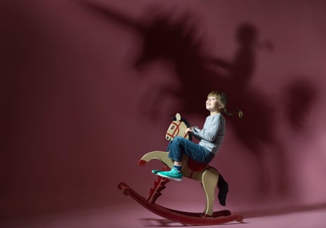 Robin, aged 6, on a rocking horse, the shadow of a unicorn behind her