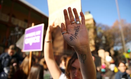 A pro-choice demonstrator displays a slogan written on her hand as she rallies outside NSW Parliament on Tuesday.