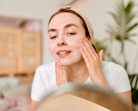 A woman cleaning her face