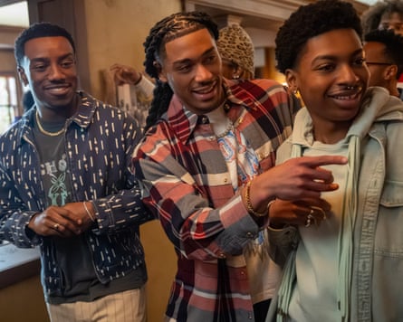 Three men smiling and looking off camera